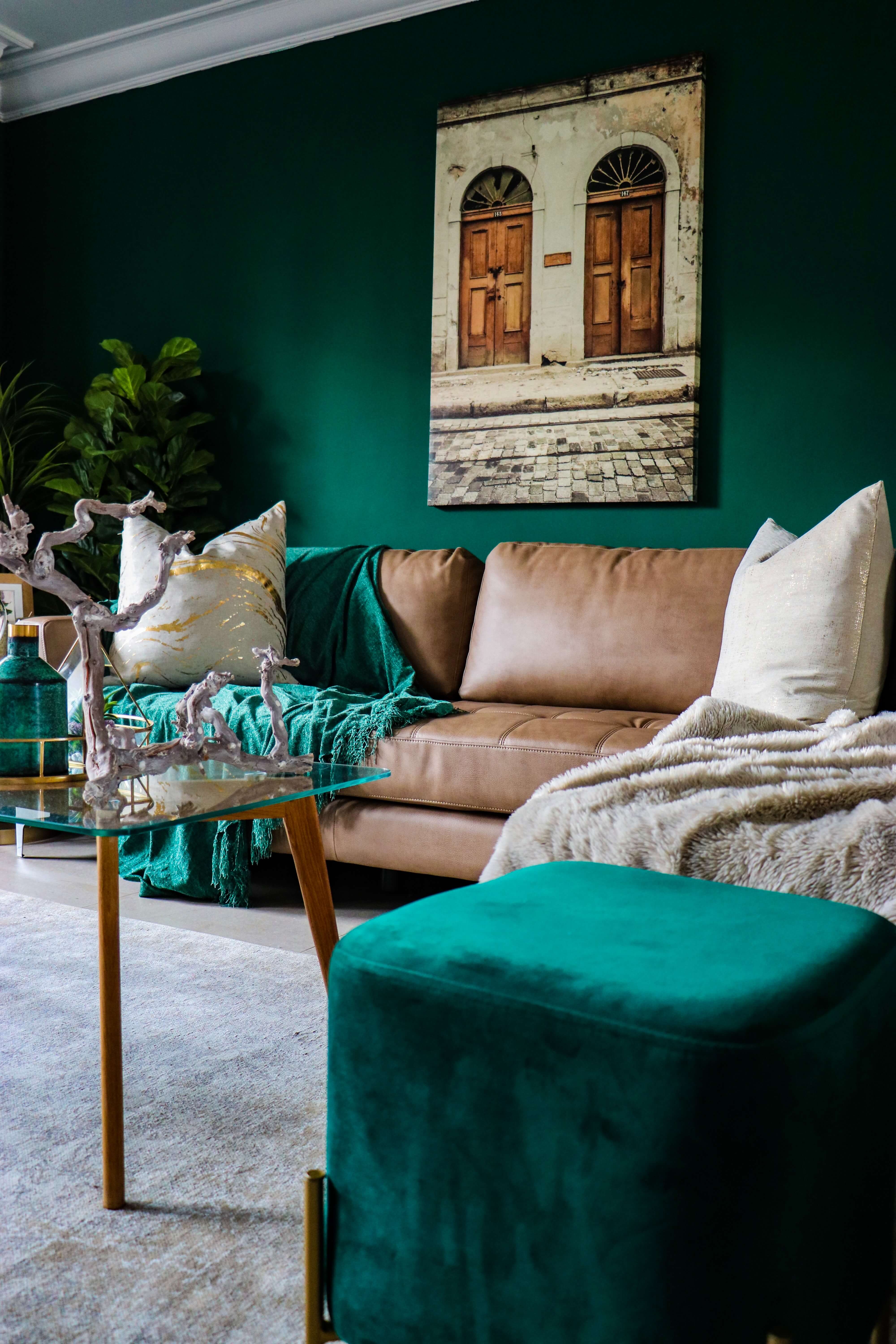 bold green cozy living room with plush pillows and fuzzy throws